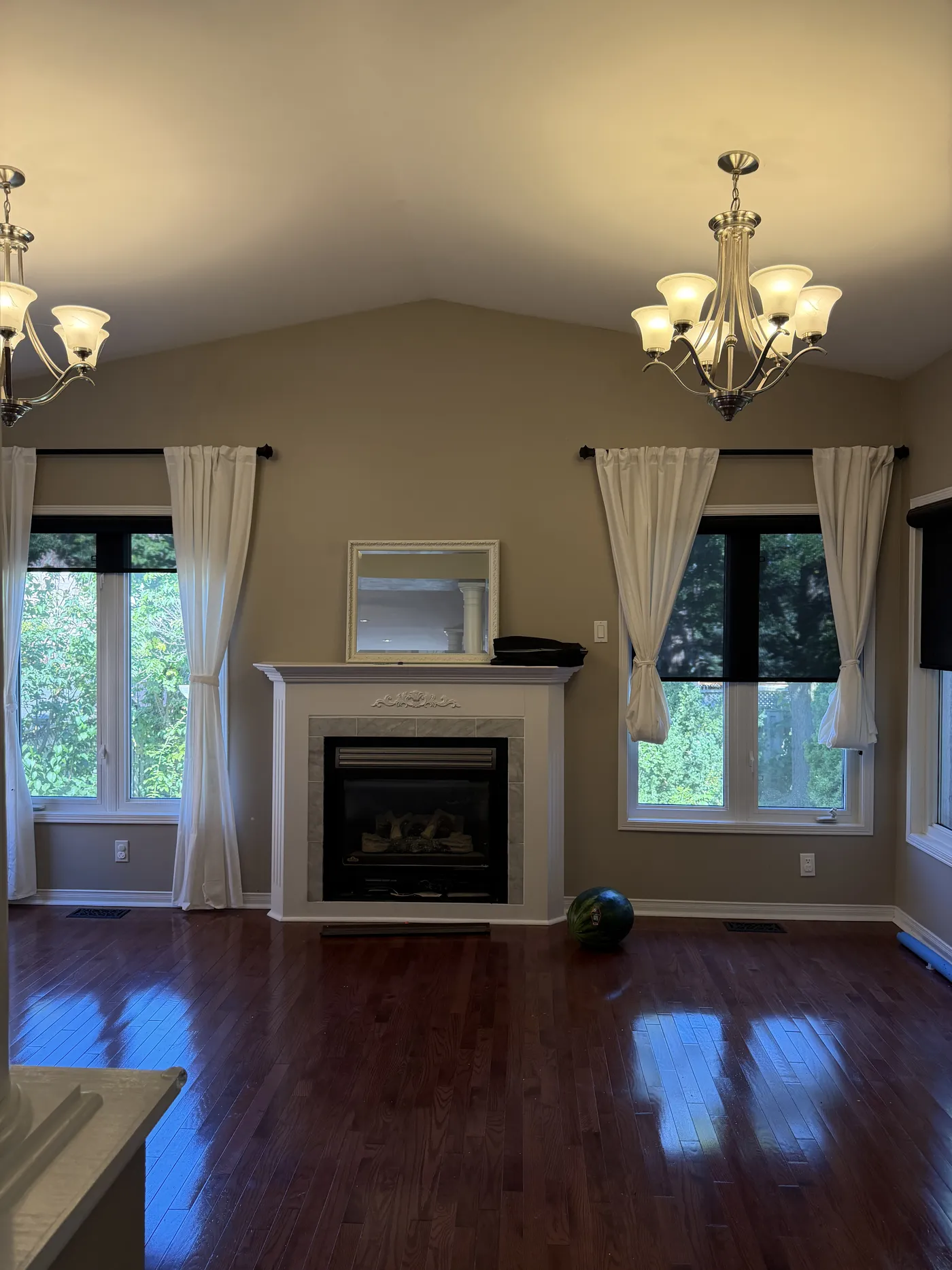 The family room before: a small fireplace between two windows.