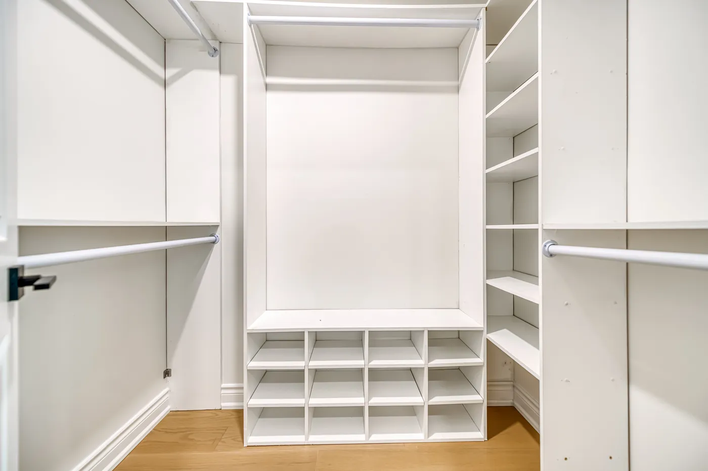 A walk-in closet with built-in shelving.