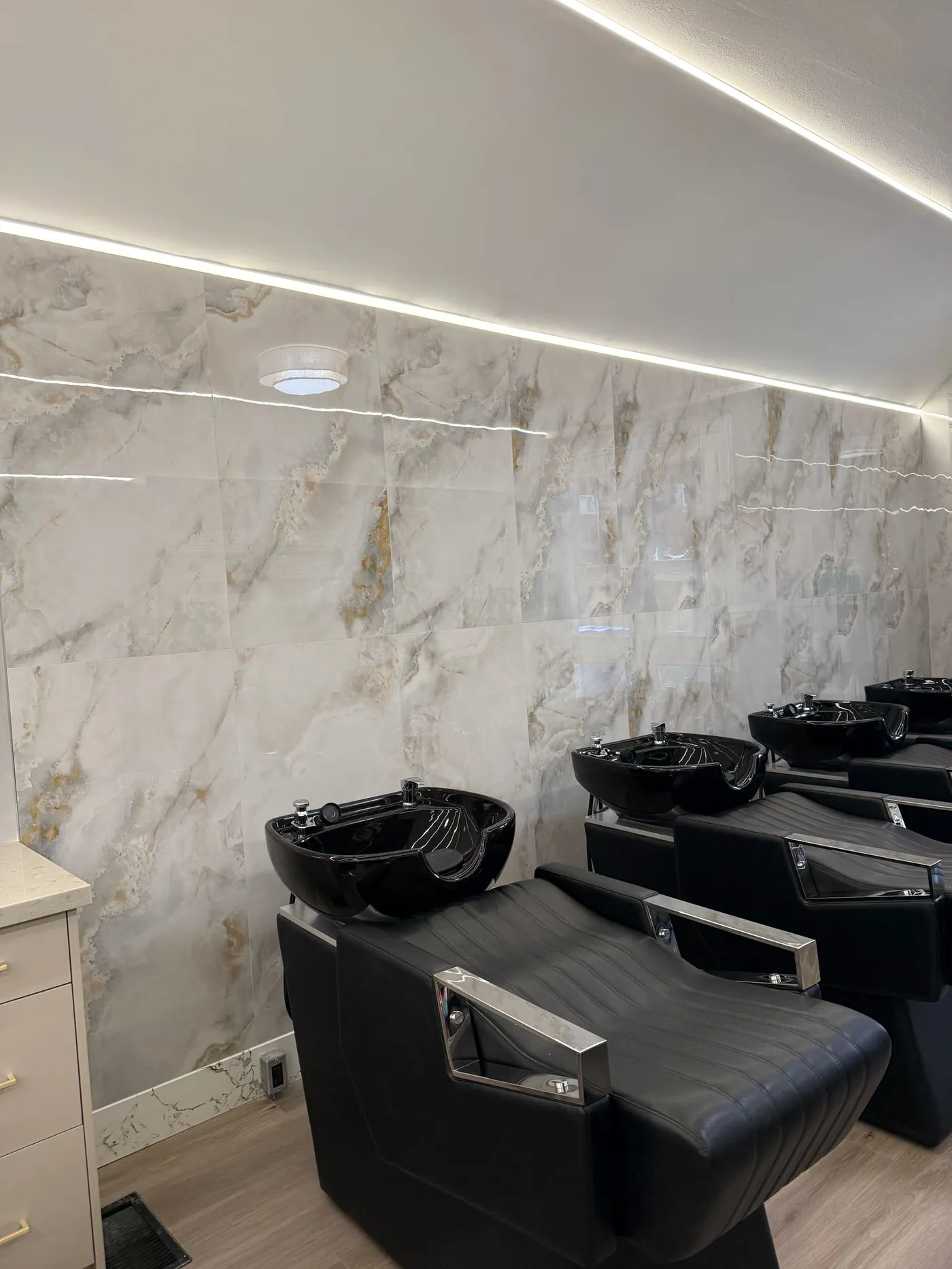 The finished wash stations against marble tile.